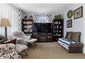 Comfortable living room featuring modern furniture, large TV, and shelving units at 6751 Locust St, Commerce City, CO 80022