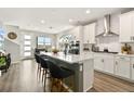 Open concept kitchen with island and stainless steel appliances at 7875 Yampa River Ave, Littleton, CO 80125