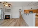 Inviting living area featuring a fireplace and hardwood floors, next to an open kitchen concept at 8615 W Berry Ave # 204, Littleton, CO 80123