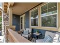 Cozy front porch with seating, neutral decor, and charming details creating an inviting outdoor space at 25245 E Park Crescent Dr, Aurora, CO 80016
