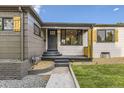 Home featuring a charming front entry and well manicured front yard at 1640 Iola St, Aurora, CO 80010