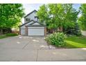 Charming two-story home with a well-manicured lawn and mature trees providing shade at 10356 Lions Heart, Lone Tree, CO 80124