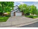 Charming two-story home with a well-manicured lawn and mature trees providing shade at 10356 Lions Heart, Lone Tree, CO 80124