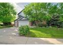 Charming two-story home with a well-manicured lawn and mature trees providing shade at 10356 Lions Heart, Lone Tree, CO 80124