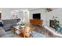 Open-concept living room featuring fireplace, mounted TV, and comfortable seating at 14435 E 1St Dr # B2, Aurora, CO 80011