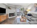 Bright living room with fireplace, hardwood floors, and a slider to the balcony at 14435 E 1St Dr # B2, Aurora, CO 80011