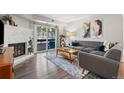 Cozy living room with a brick fireplace, sliding glass doors to balcony, and comfortable seating at 14435 E 1St Dr # B2, Aurora, CO 80011