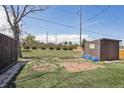 Secluded backyard with a small shed, brick patio area, privacy fence, and mature landscaping at 10505 Clarkson St, Northglenn, CO 80233