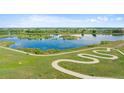 Scenic view of a community lake with walking trails and lush landscaping under a blue sky at 12826 Lake Port St, Longmont, CO 80504