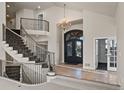Grand foyer with curved staircase, high ceilings, chandelier, and a view of the front door at 4505 W 100Th Ave, Westminster, CO 80031
