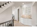 Hallway with custom built-in cabinets, granite countertop, and view to the kitchen at 4505 W 100Th Ave, Westminster, CO 80031