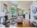 Inviting living room with hardwood floors, a fireplace, and large windows offering ample natural light at 6827 S Webster St # E, Littleton, CO 80128