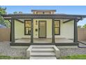 Inviting front porch featuring sleek design elements, modern columns, and a clear house number at 3975 Yates St, Denver, CO 80212
