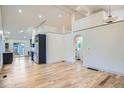 Bright and airy living room featuring hardwood floors, high ceilings, and an open-concept layout to the kitchen at 3975 Yates St, Denver, CO 80212