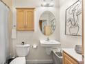 A clean, well-lit bathroom with a modern vanity, a framed mirror and black and white art at 1950 N Logan St # 905, Denver, CO 80203