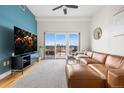Stylish living room with comfortable seating, a sleek entertainment center, and balcony access at 1950 N Logan St # 905, Denver, CO 80203