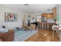 Open-concept living space boasts hardwood floors, modern furnishings, and a seamless flow to the kitchen at 2810 N Harrison St, Denver, CO 80205