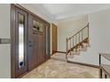 Welcoming entryway featuring tile flooring and a staircase, creating a warm and inviting ambiance at 302 Northridge Rd, Highlands Ranch, CO 80126
