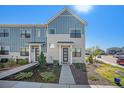 Charming townhome showcasing modern architecture, with landscaped front yard and inviting entrance at 7889 Yampa River Ave, Littleton, CO 80125