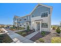 Desirable townhome featuring attractive curb appeal, a well-maintained lawn, and inviting front entrances at 7889 Yampa River Ave, Littleton, CO 80125