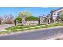 Stone entrance to Shadow Canyon with lovely landscaping and building exterior on a bright day at 4605 Copeland Loop # 103, Highlands Ranch, CO 80126