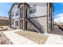 Stylish two-story townhouse with modern exterior, clean landscaping, and stairs to the unit's front door at 4605 Copeland Loop # 103, Highlands Ranch, CO 80126