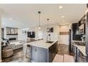 Well-lit kitchen featuring a marble countertop island and stainless steel appliances at 14315 Big Stone Dr, Parker, CO 80134