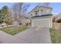 Well-maintained two-story home featuring an attached two-car garage and a manicured lawn at 11223 Jansen St, Parker, CO 80134