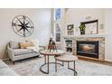 Cozy living room with a stone fireplace, comfortable seating, and elegant decor at 11223 Jansen St, Parker, CO 80134