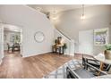 Inviting living room with high ceilings and wood flooring, complemented by stylish furnishings and natural light at 11223 Jansen St, Parker, CO 80134