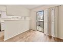 View of the doorway leading to the exterior fenced patio from the home's bright, light-filled living area at 17053 E Tennessee Dr # 101, Aurora, CO 80017