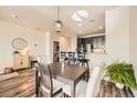 Dining area featuring a modern pendant light, a view of the kitchen, and stylish decor at 1817 S Buchanan Cir, Aurora, CO 80018