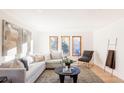 Bright living room featuring hardwood floors, large windows, and neutral decor at 1 Winged Foot Way, Littleton, CO 80123