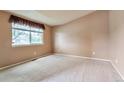 Cozy bedroom with neutral carpet, light walls, a window with valance, and ample natural light at 6731 E 128Th Pl, Thornton, CO 80602