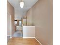 Inviting entryway featuring light hardwood flooring, neutral paint, and an open view into the living space at 6731 E 128Th Pl, Thornton, CO 80602
