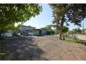 A large backyard with trees and driveway at 1075 S Ames St, Lakewood, CO 80226