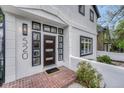 Close-up of a modern entryway featuring a stylish front door with sidelights and a brick landing at 520 Columbine St, Denver, CO 80206
