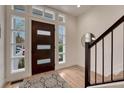 Inviting foyer with modern wood door, sidelight windows, and a patterned rug on the light hardwood floor at 520 Columbine St, Denver, CO 80206