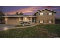 Beautiful two-story home with an attached two car garage under a colorful sunset at 6298 S Harlan Way, Littleton, CO 80123