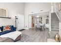 Inviting living room with hardwood floors, staircase, and abundant natural light creating a warm and welcoming atmosphere at 970 S Dawson Way # 15, Aurora, CO 80012