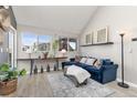 Living room showcasing vaulted ceilings, neutral walls, light wood floors and view to the outside at 970 S Dawson Way # 15, Aurora, CO 80012