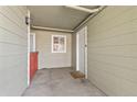 A cozy outdoor patio with a white door and window, ideal for creating a private and relaxing space at 970 S Dawson Way # 15, Aurora, CO 80012