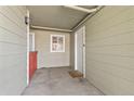 Covered patio area with a door and window, offering a private outdoor space at 970 S Dawson Way # 15, Aurora, CO 80012