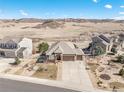 An aerial view of a home with a spacious yard, professional landscaping, and mountain views at 5238 Clearbrooke Ct, Castle Rock, CO 80104