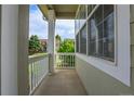 Inviting front porch with white railings, offering a view of the front yard and neighborhood street at 10115 Foxridge Ct, Highlands Ranch, CO 80126