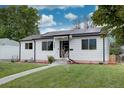 A charming home with a well-kept lawn, solar panels, and inviting curb appeal at 2389 Nome St, Aurora, CO 80010