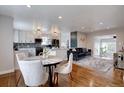 Open-concept living and dining space with hardwood floors and stylish decor at 2389 Nome St, Aurora, CO 80010