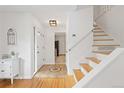 Bright foyer with hardwood floors and a staircase, creating a welcoming entrance to the home at 8390 E Davies Pl, Centennial, CO 80112
