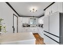 Bright kitchen featuring white cabinets, a marble countertop, and hardwood floors at 1060 W 133Rd Cir # C, Denver, CO 80234