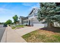 Light blue two-story house with a two-car garage, porch, and a well-maintained lawn at 5009 Mt Osage St, Frederick, CO 80504